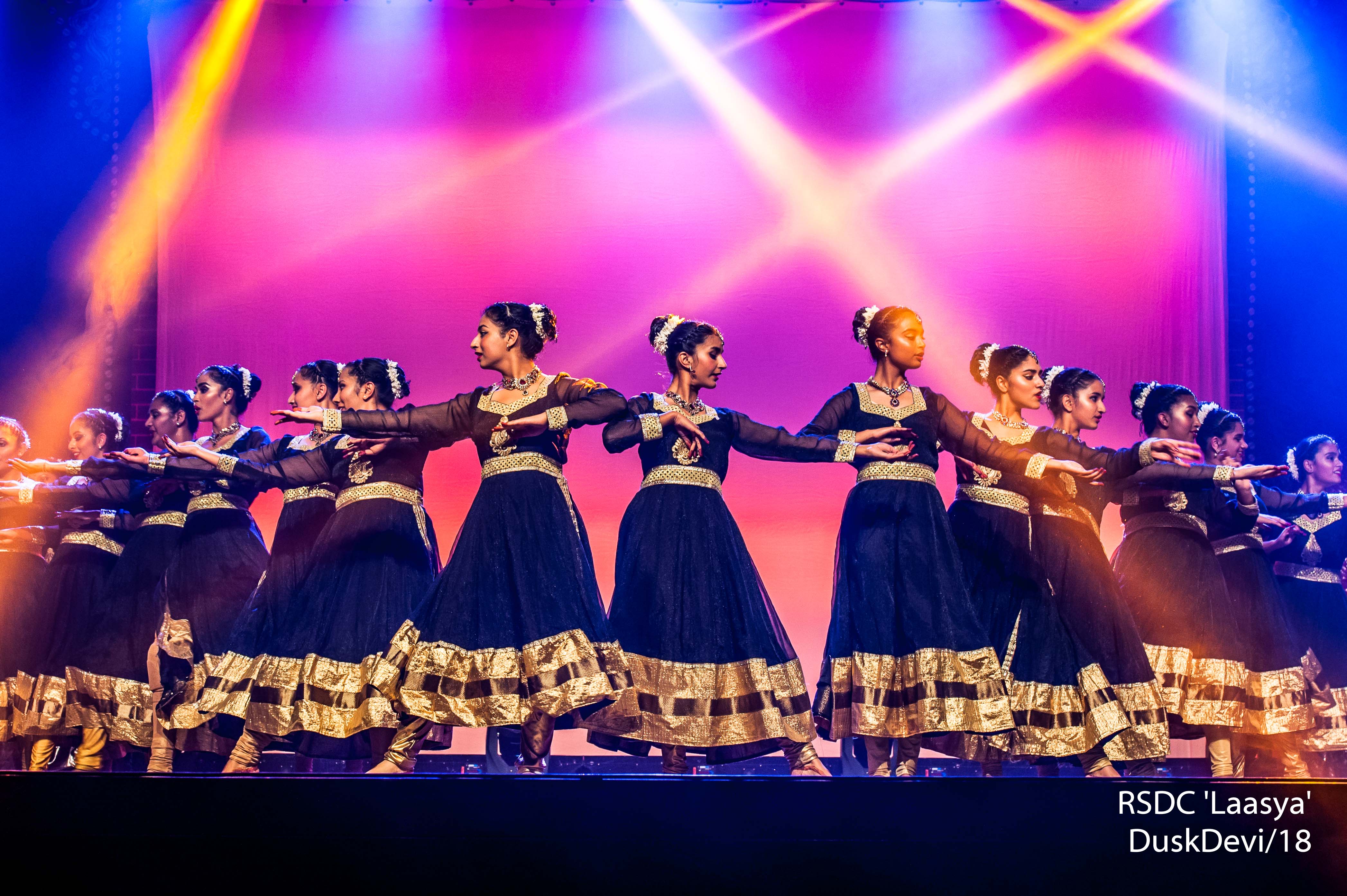 Ruchi Sanghi Dance Company Banner dancers mid performance in mirrored formation