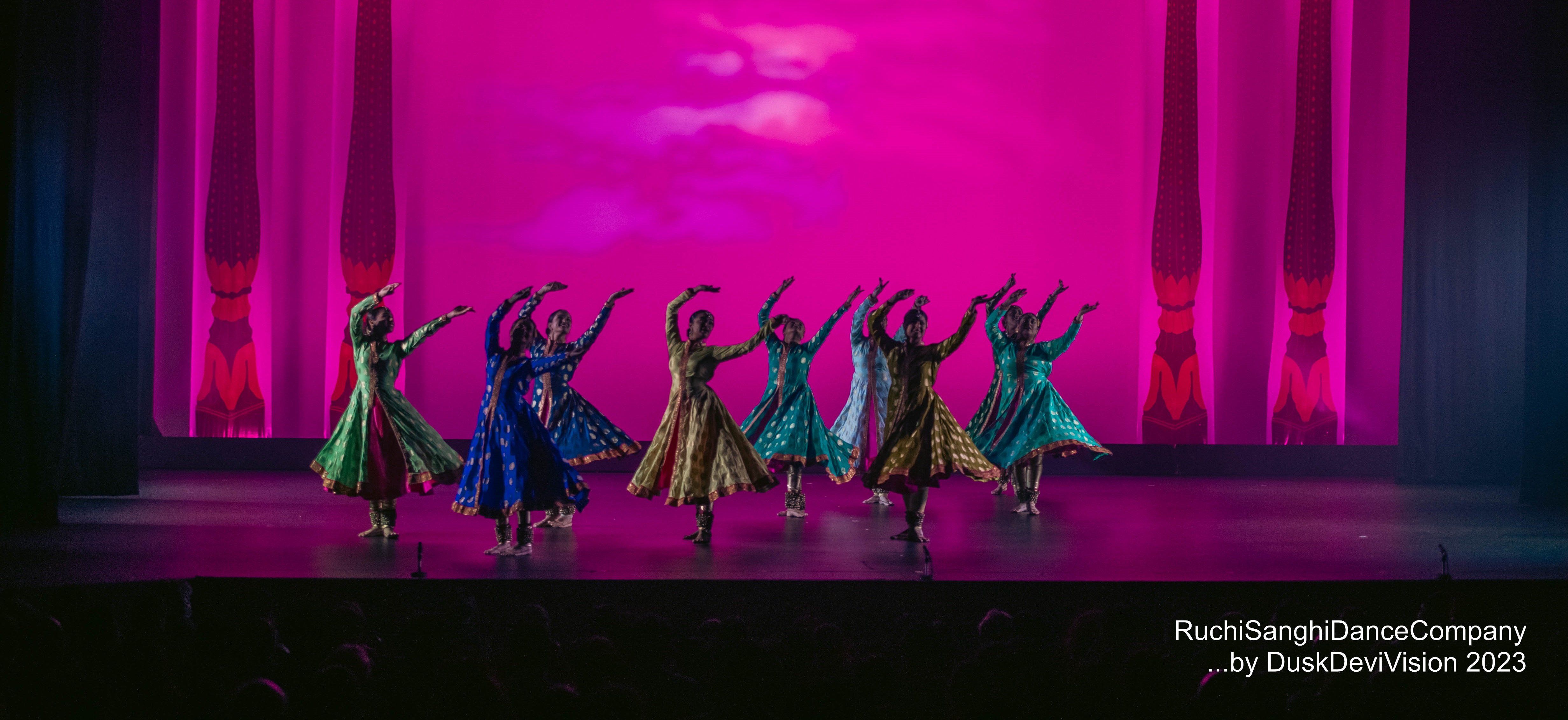 Ruchi Sanghi Dance Company Gallery Banner dancers mid performance on pink stage